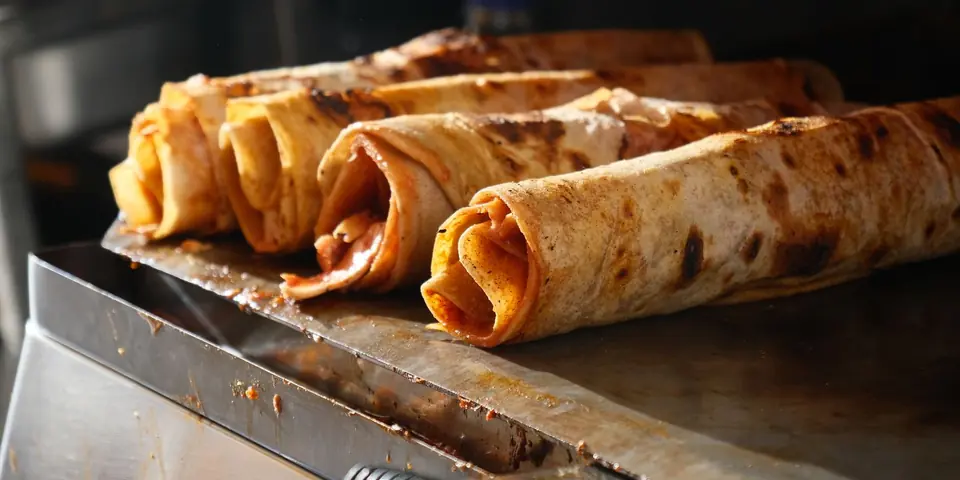 Dürüms crisping on the griddle
